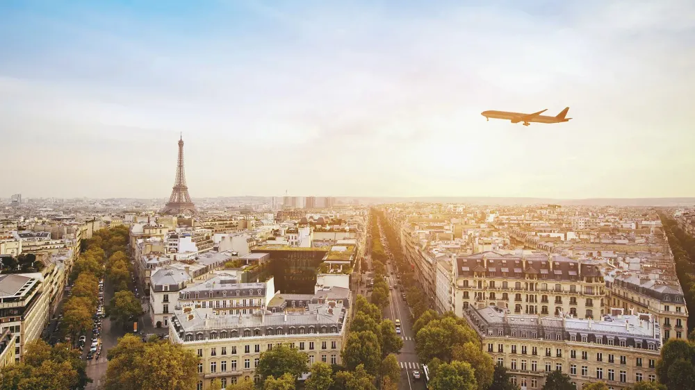 airplane flying over eiffel tower in paris france